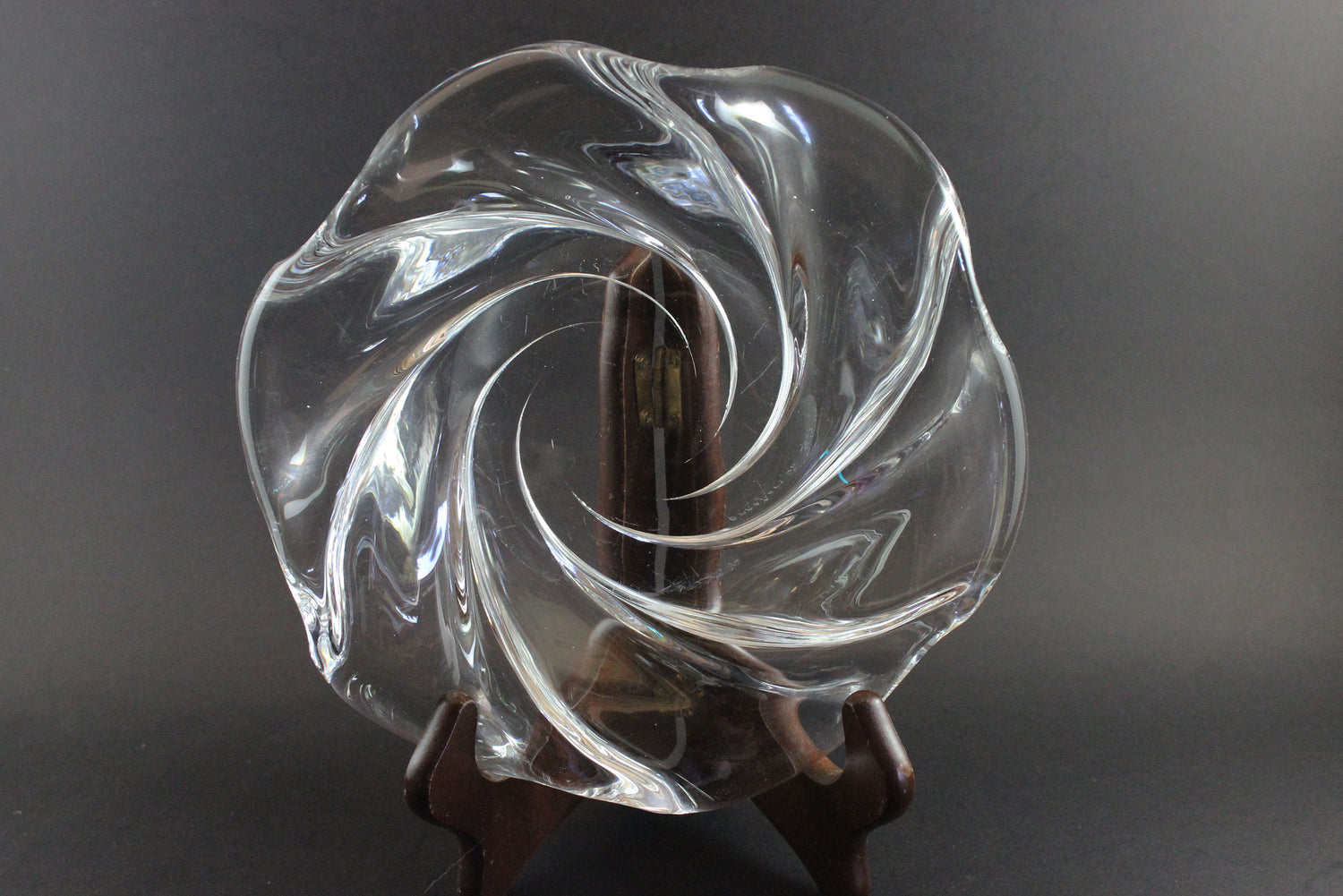 Clear crystal bowl with wavy design on a black background