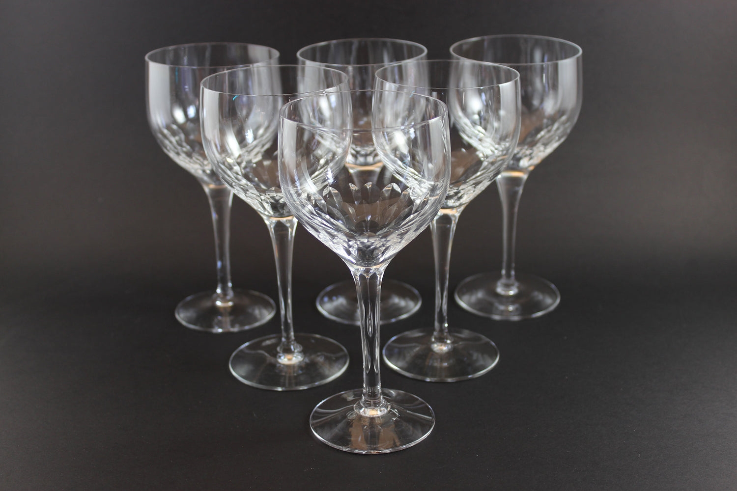 Set of six clear Orrefors Prelude wine glasses on a dark background