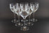 Set of six clear Orrefors Prelude wine glasses on a dark background