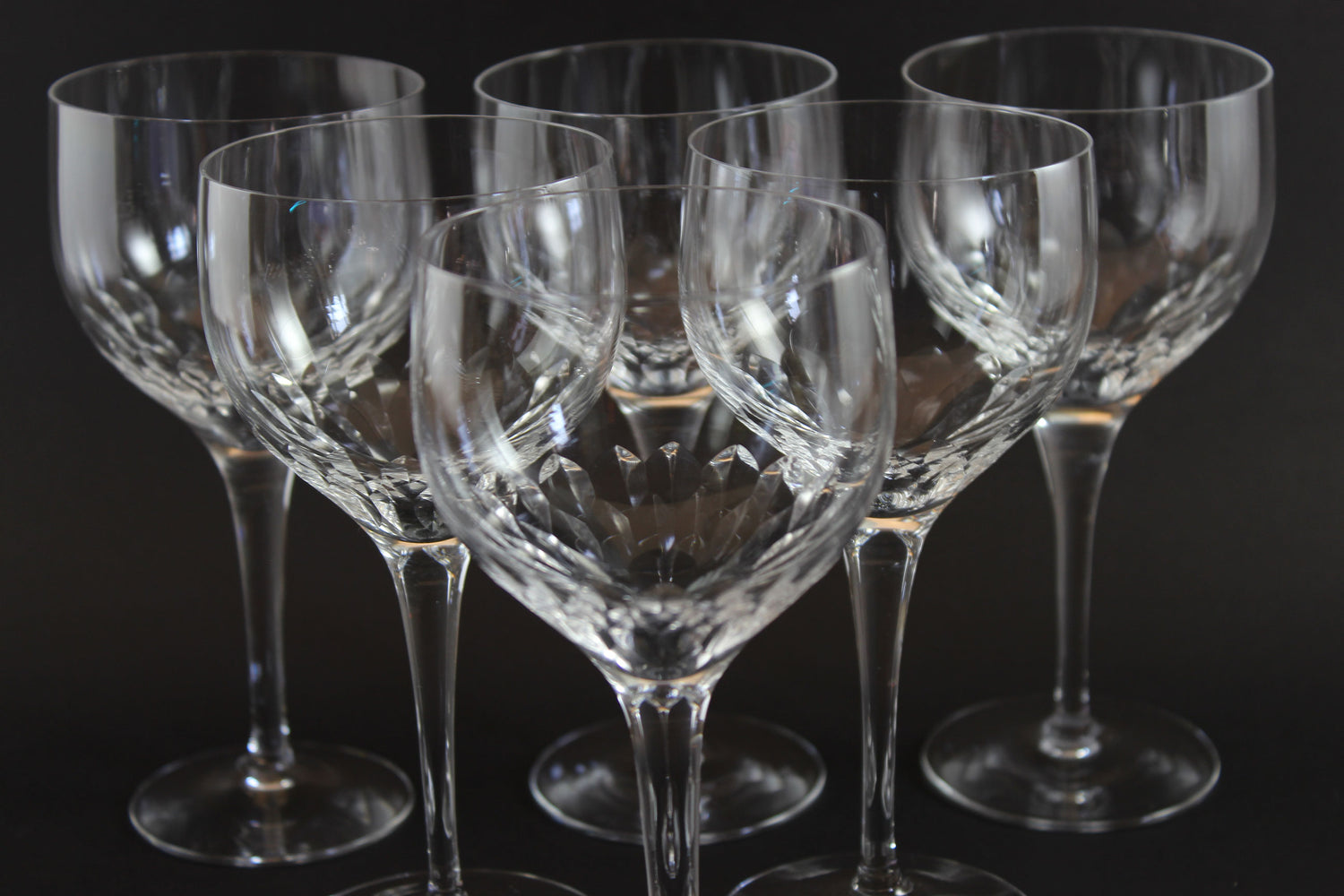 Set of six clear Orrefors Prelude wine glasses on a dark background