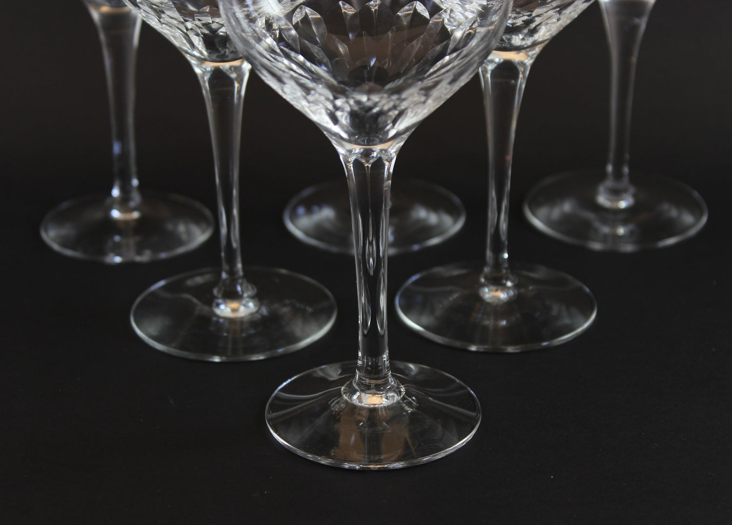 Set of six clear Orrefors Prelude wine glasses on a dark background