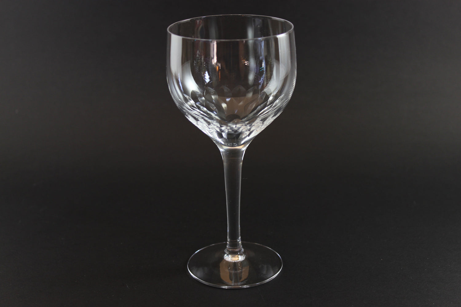 Set of six clear Orrefors Prelude wine glasses on a dark background
