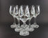 Set of clear wine glasses on a black background