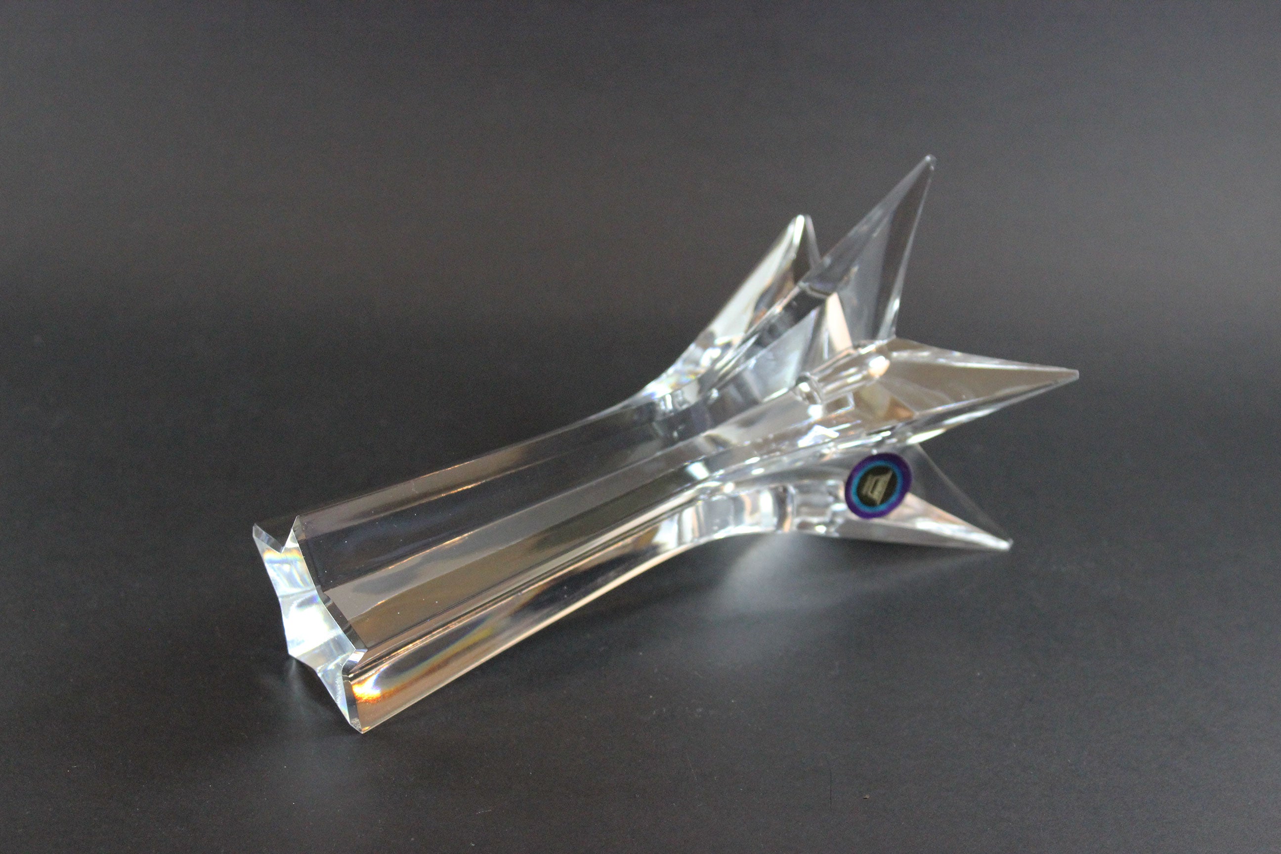 Set of crystal star-shaped candleholders on a dark background