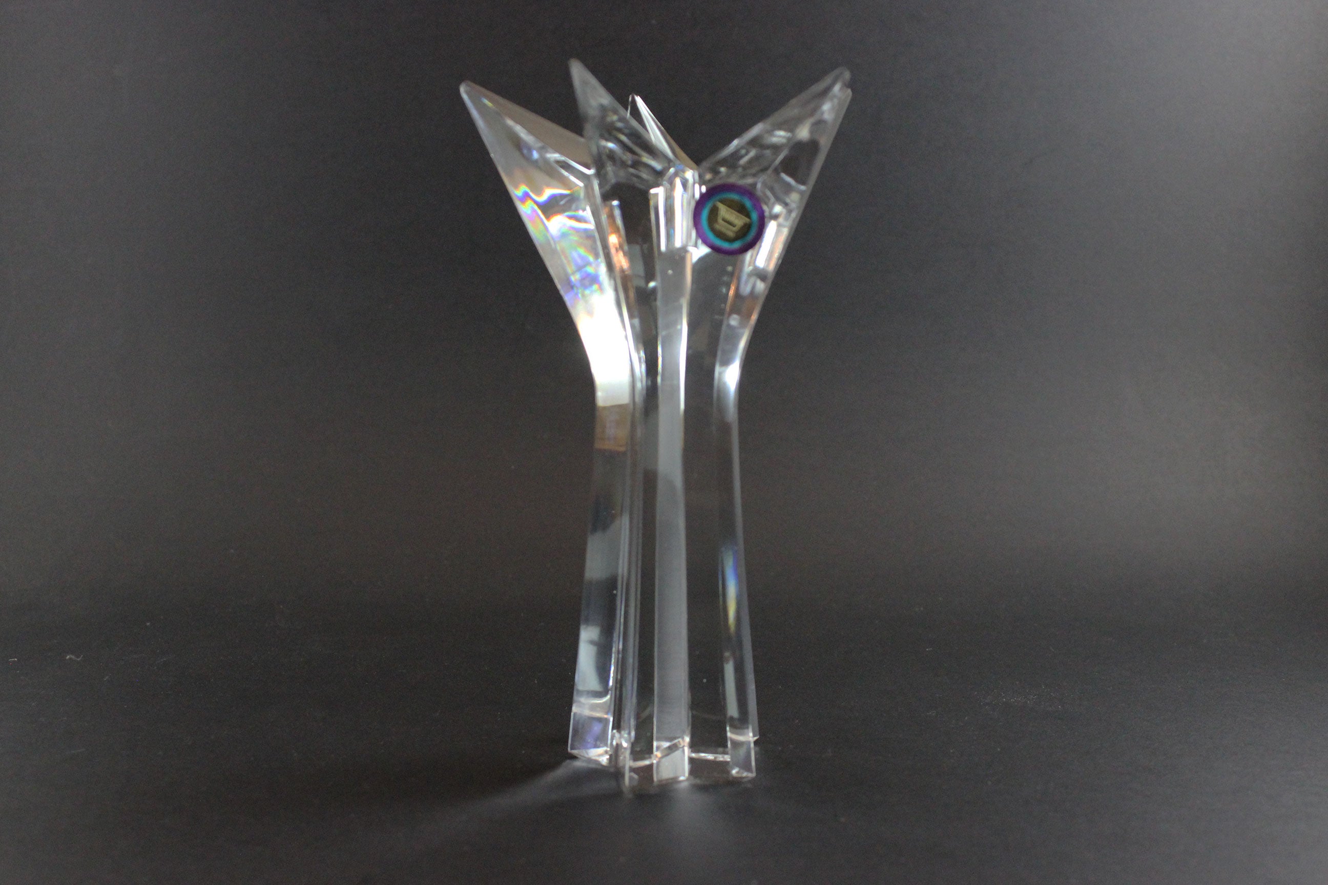 Set of crystal star-shaped candleholders on a dark background