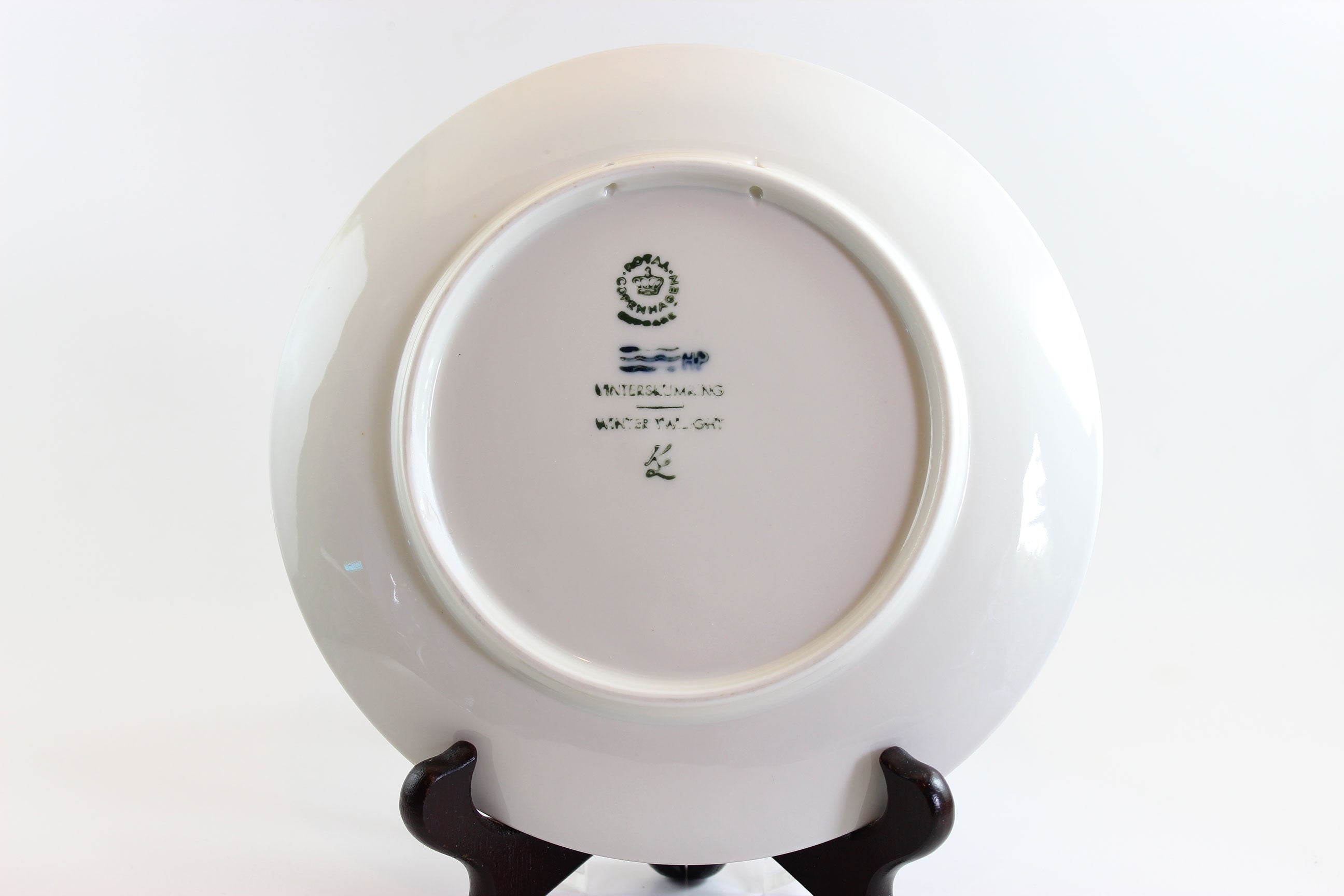 1974 Royal Copenhagen Blue ceramic plate with winter scene and owl, on a white background.
