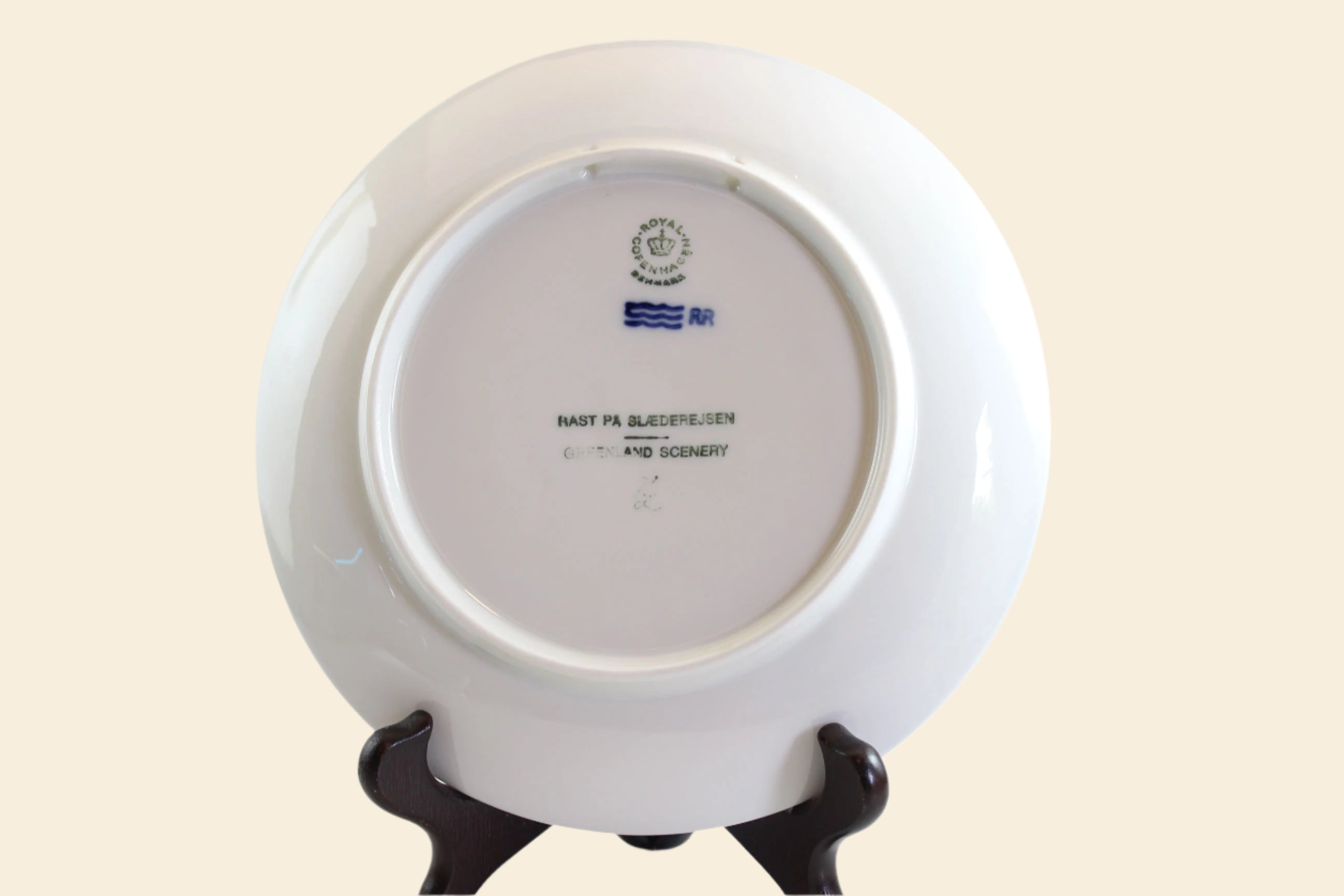 White ceramic plate with a stand on a white background