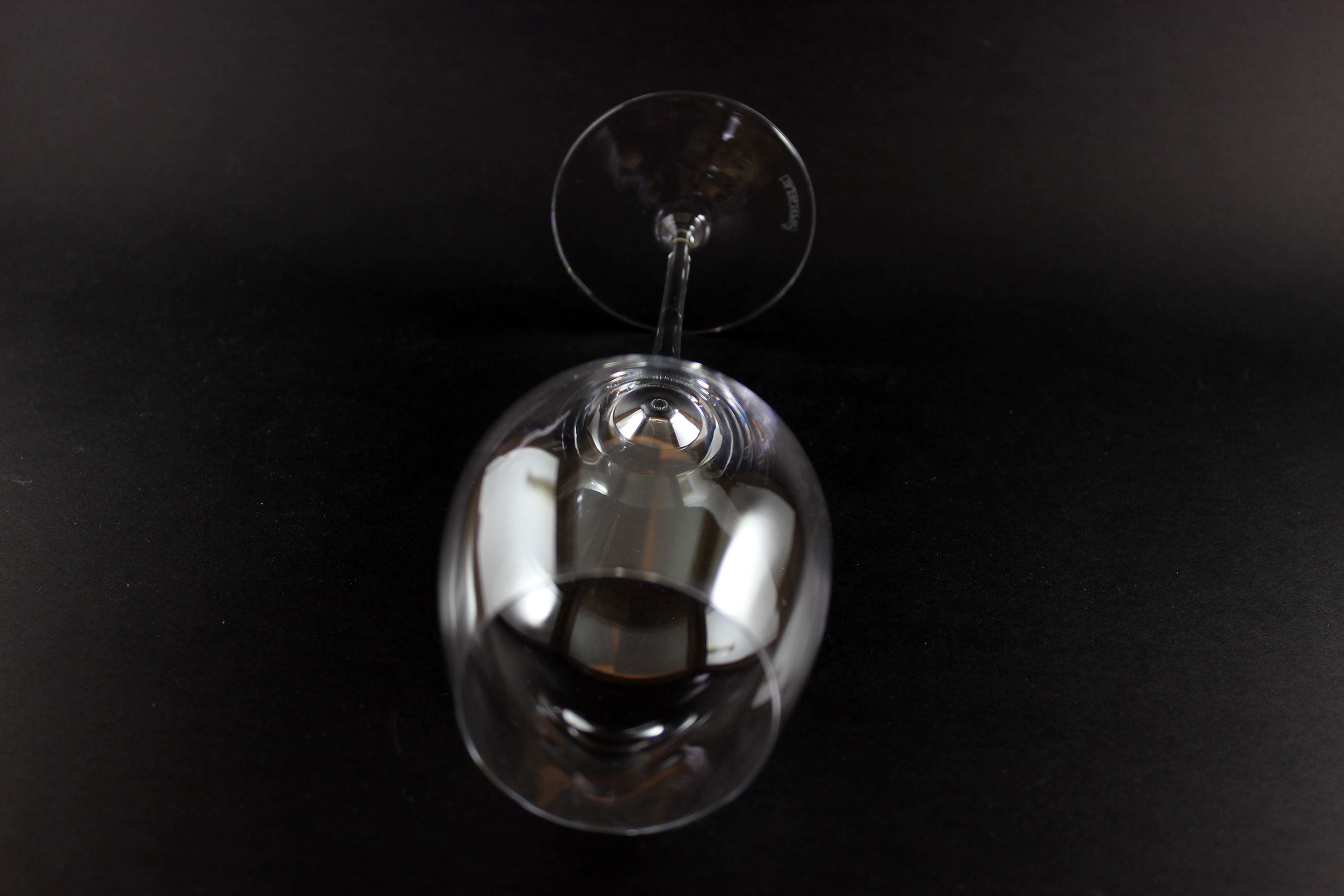 Clear wine glass on a black background