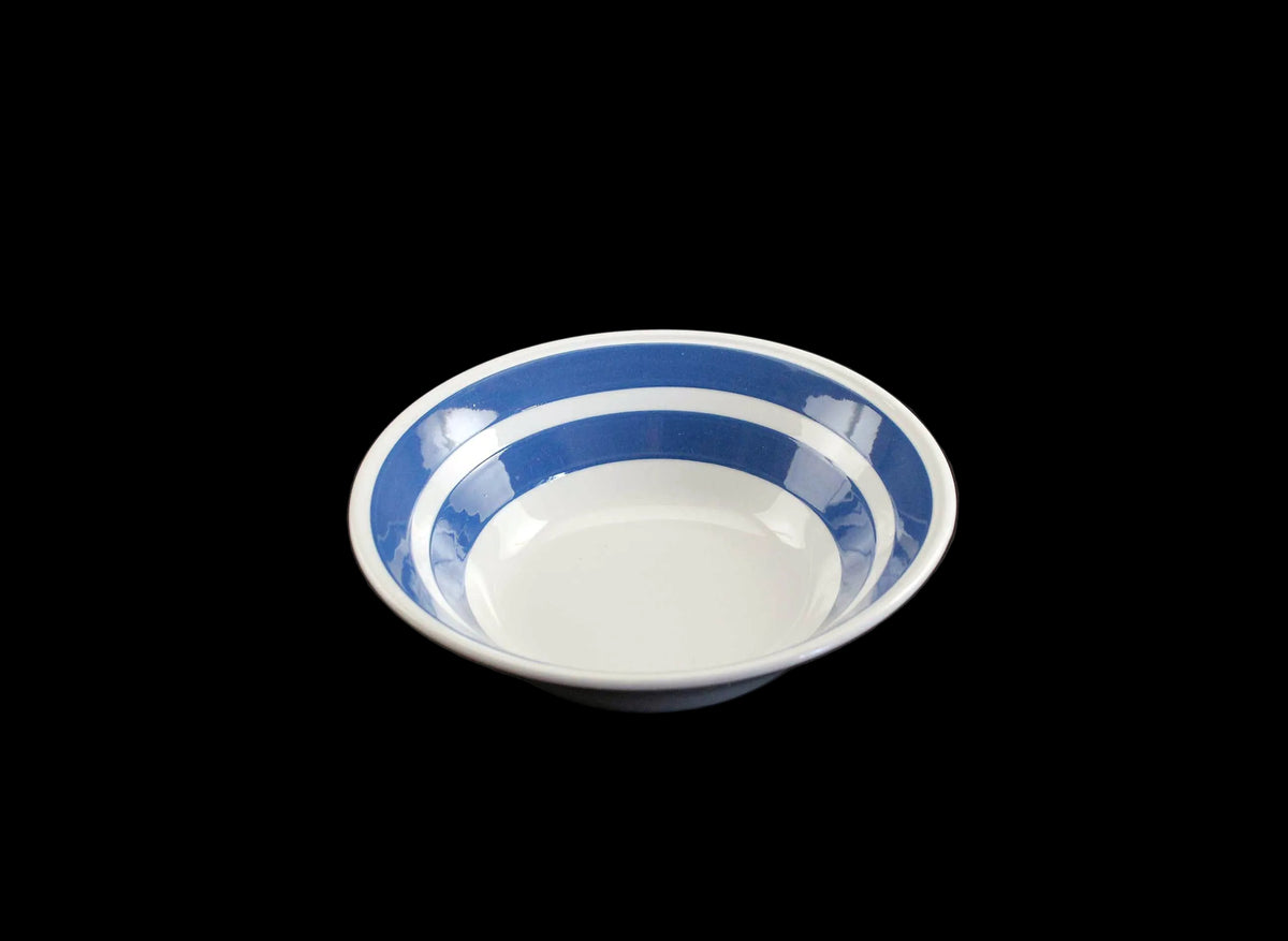 White ironstone cereal bowl with blue stripes in Cornishware style.