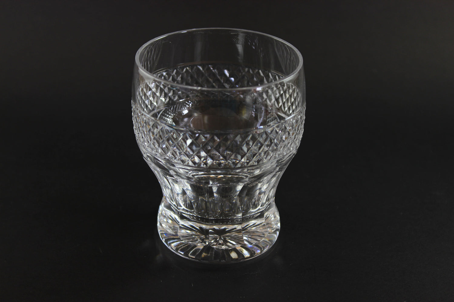 Clear glass with diamond cut pattern on a black background