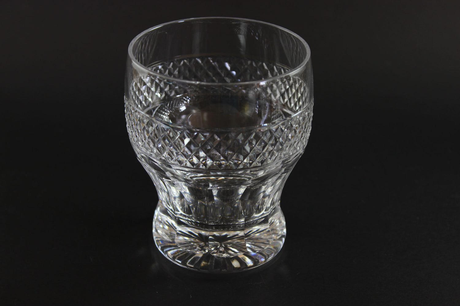 Clear glass with textured design on a black background