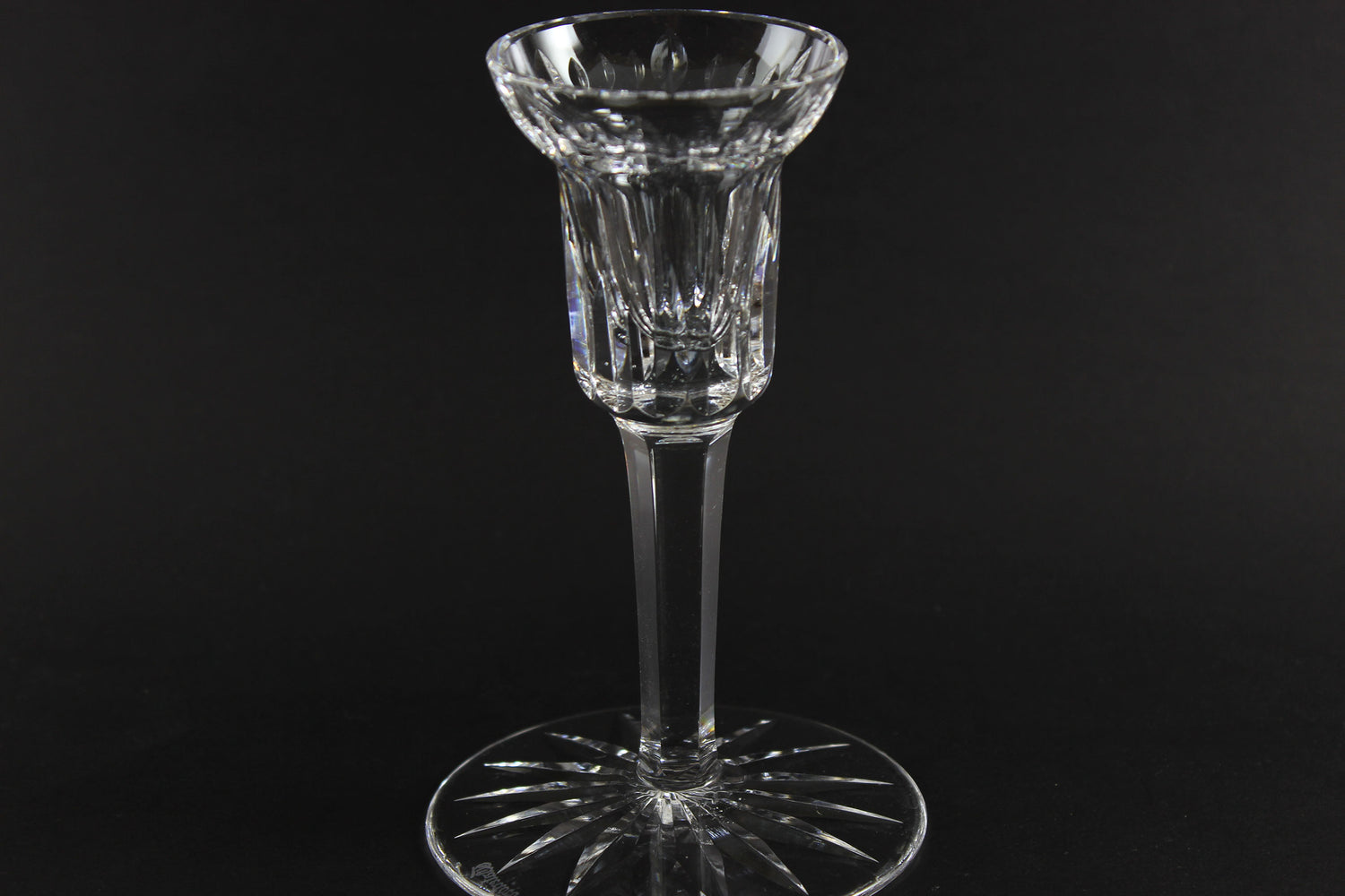 Clear crystal candlestick on a black background