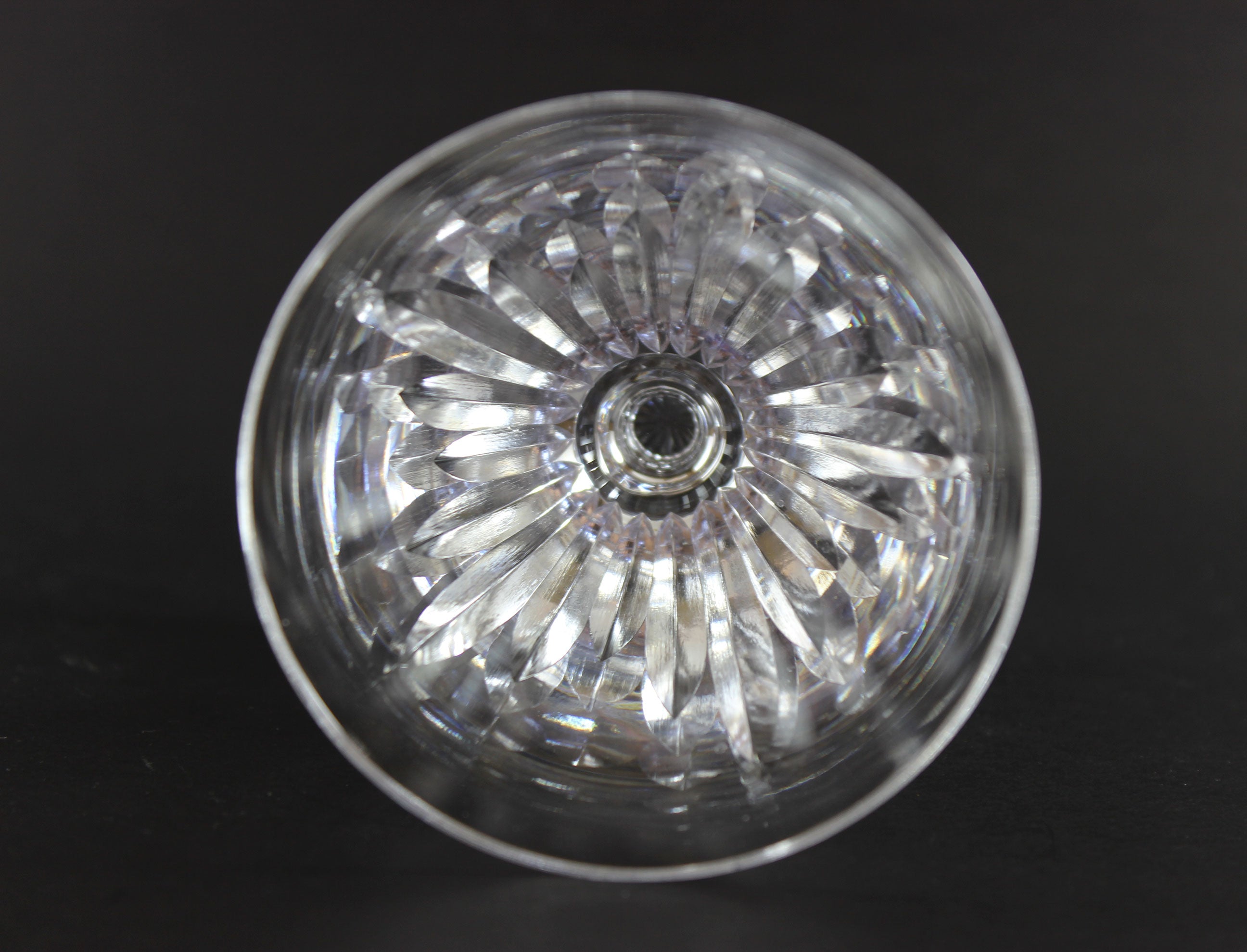 Cut crystal goblet with intricate designs on a black background