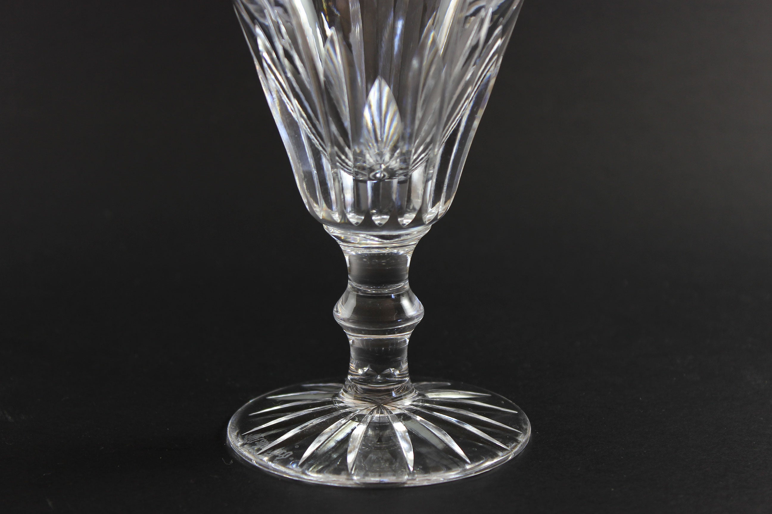 Cut crystal goblet with intricate design on a black background