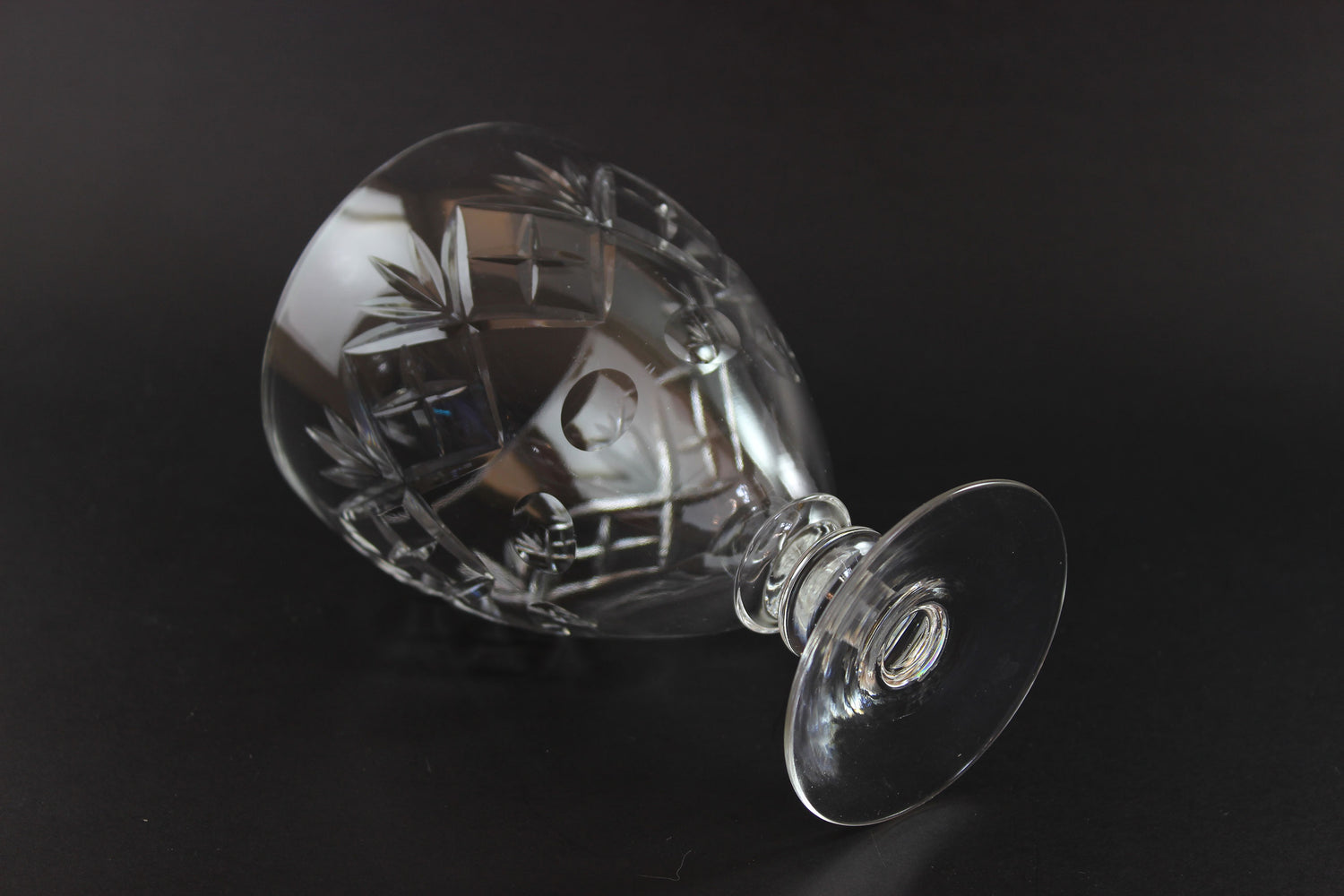 Crystal glass with engraved design on a black background