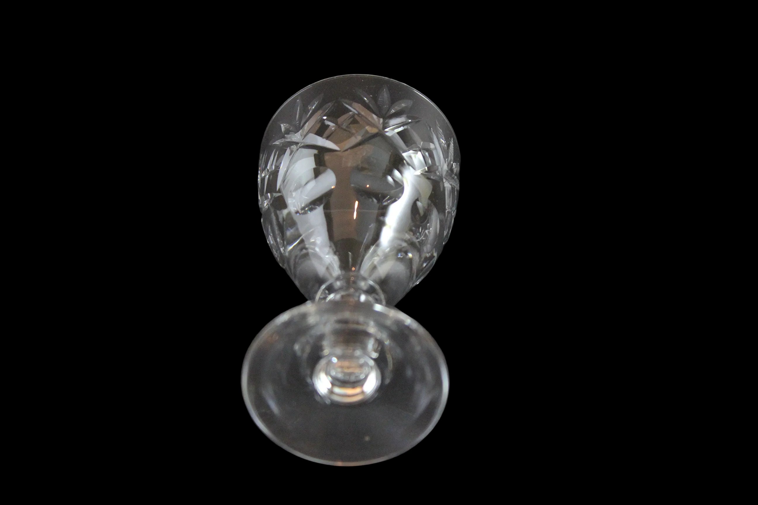 Set of six crystal sherry or port glasses on a dark background