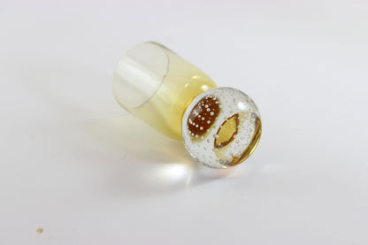 Set of amber pinched glass decanter and six glasses on a white background