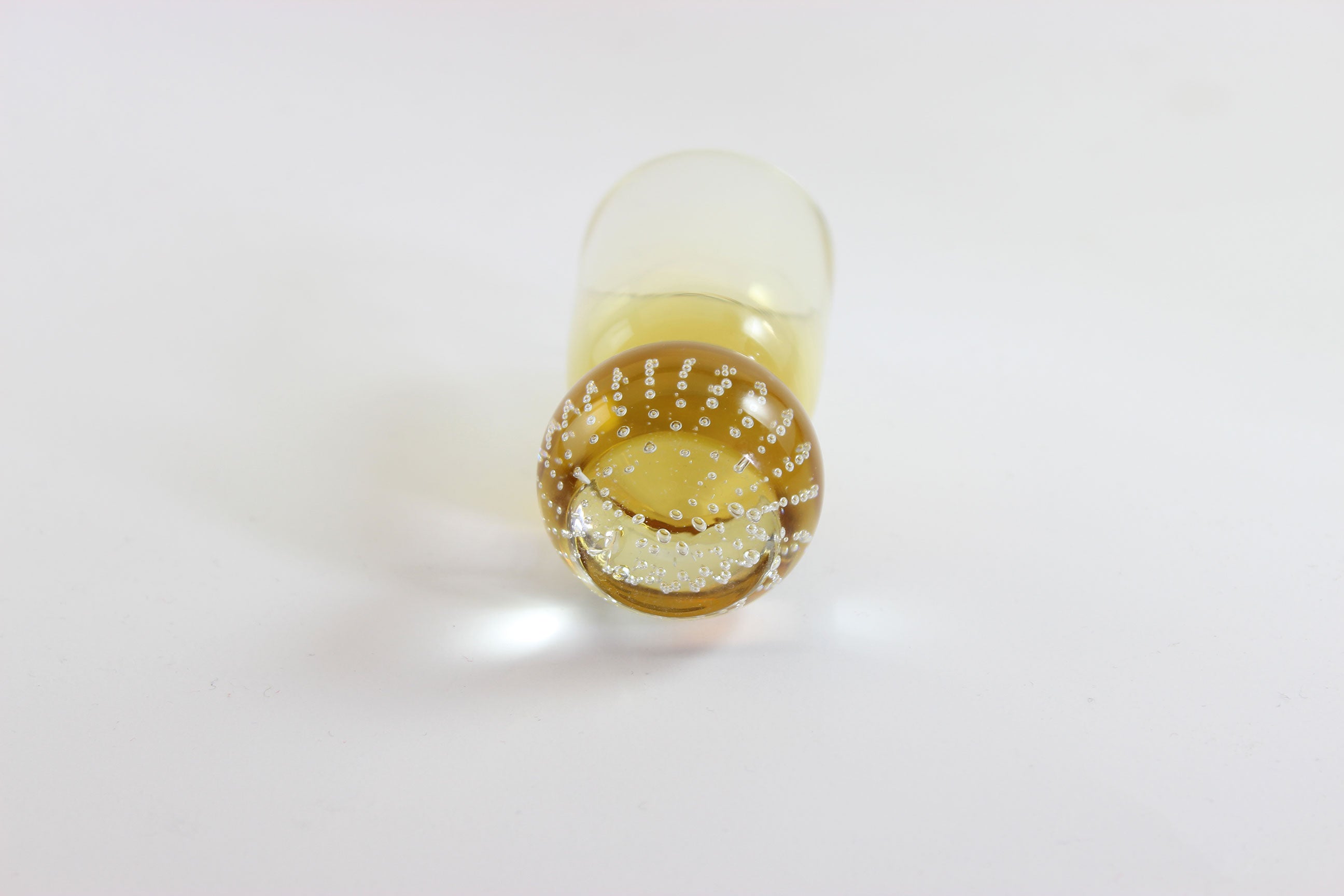 Set of amber pinched glass decanter and six glasses on a white background