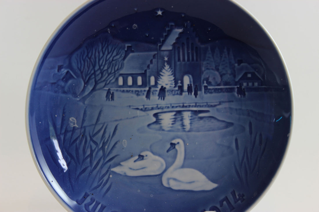 Bing and Grondahl Decorative blue plate 1974 with a winter scene featuring swans and a building.