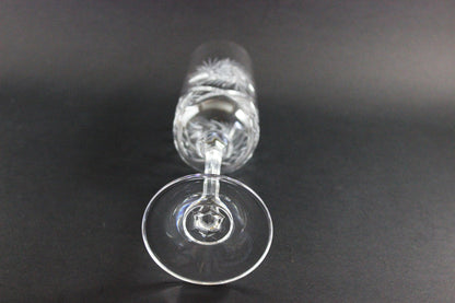 Crystal champagne flute with cut pinwheel design on a black background