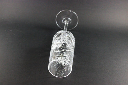 Crystal champagne flute with cut pinwheel design on a black background