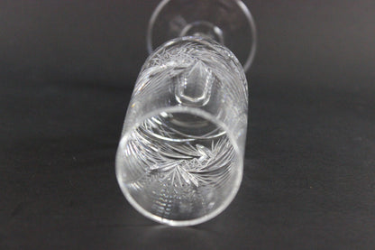 Crystal champagne flute with cut pinwheel design on a black background