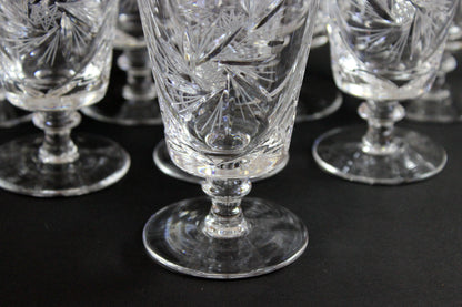 Set of crystal glasses with intricate designs on a black background