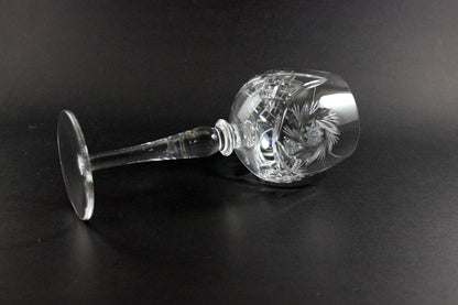 Crystal wine goblet with cut design on a black background