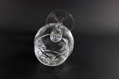 Clear crystal wine goblet with cut design on a black background