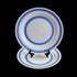 White plate with blue stripes on a black stand against a dark background