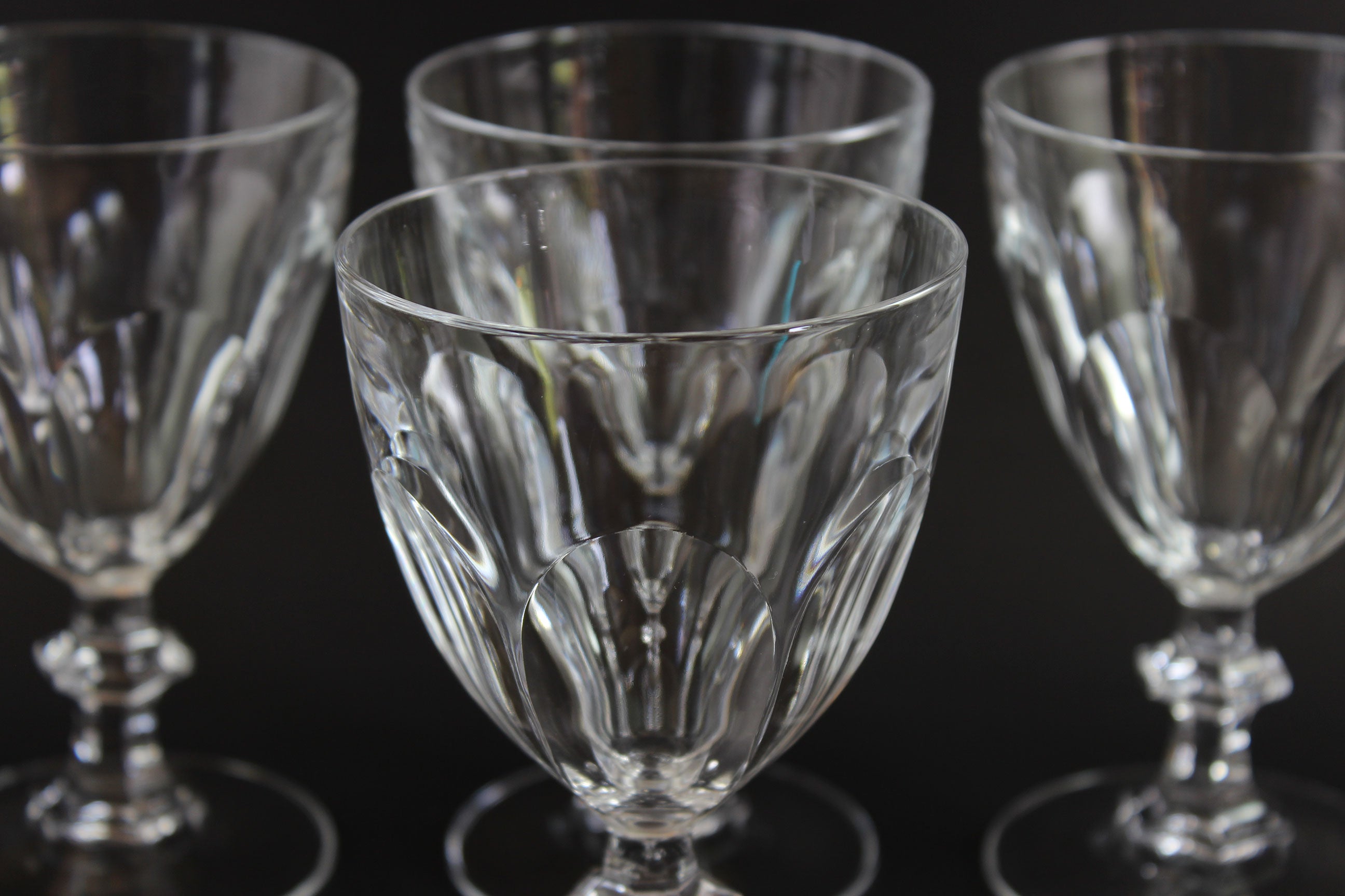 Clear, crystal Claret glasses on black background.