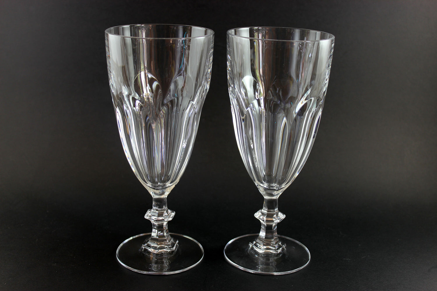 Two clear crystal goblets on a black background