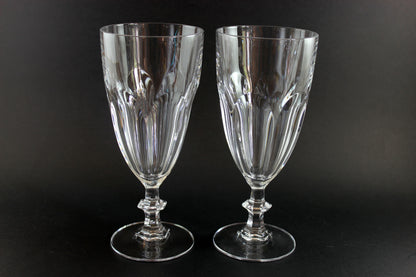 Two clear crystal goblets on a black background