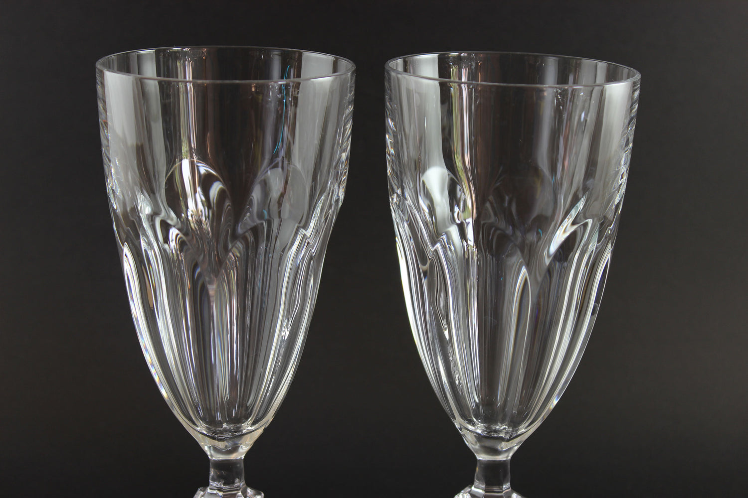 Two clear crystal goblets on a black background