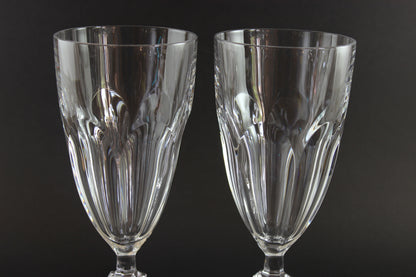 Two clear crystal goblets on a black background