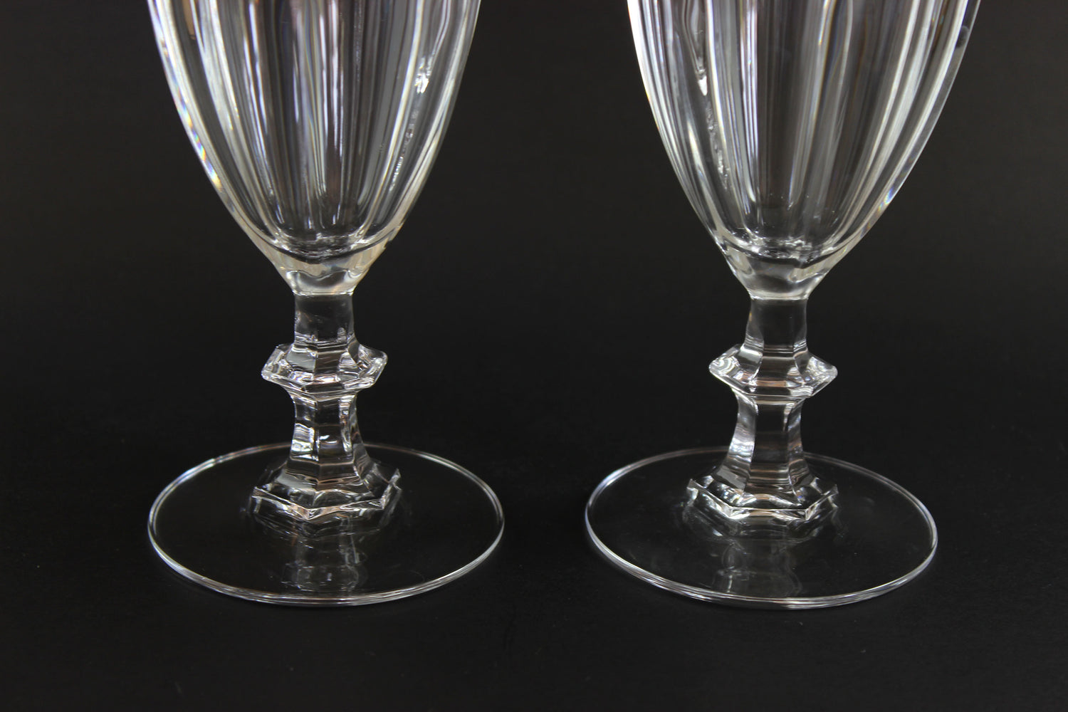 Two clear crystal goblets on a black background
