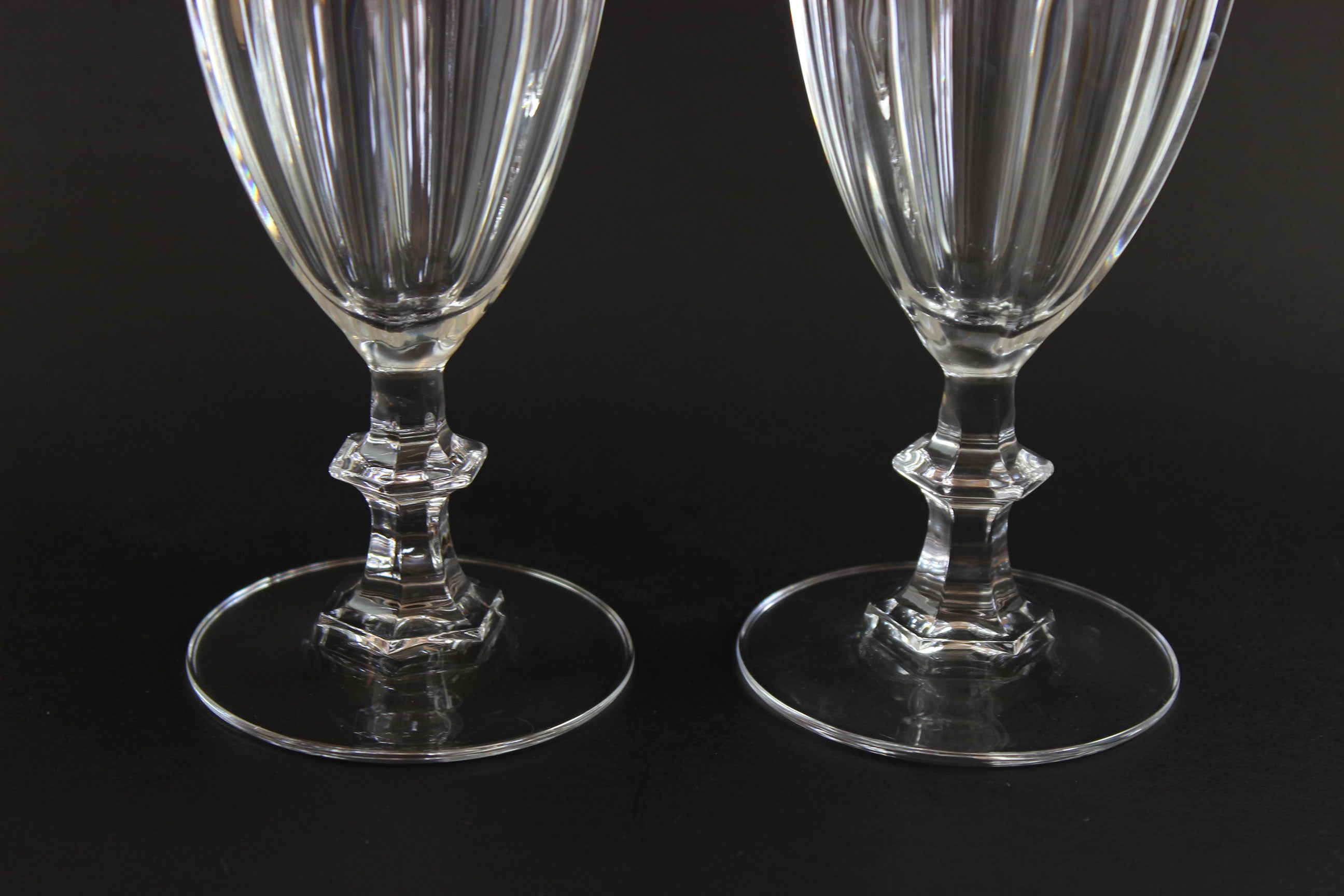 Two clear crystal goblets on a black background