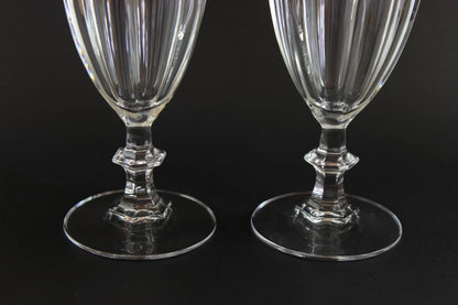 Two clear crystal goblets on a black background