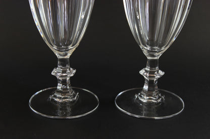 Two clear crystal goblets on a black background