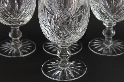 Set of crystal glasses with intricate designs on a black background