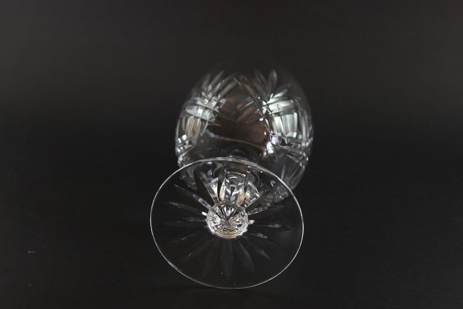 Crystal glass with cut patterns on a black background