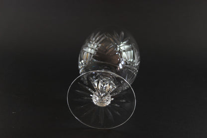 Crystal glass with cut patterns on a black background