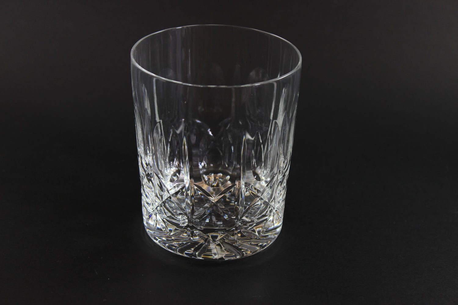Crystal glass tumbler on a black background