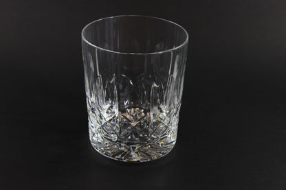 Crystal glass tumbler on a black background