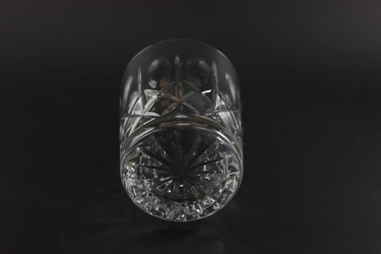 Crystal glass with cut patterns on a black background