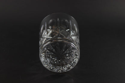 Crystal glass with cut patterns on a black background