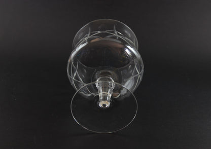Clear crystal goblet with cross and olive cut pattern on a dark background