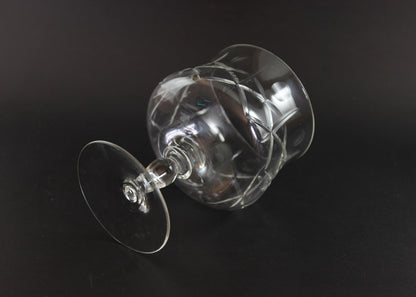 Clear crystal goblet with cross and olive cut pattern on a dark background