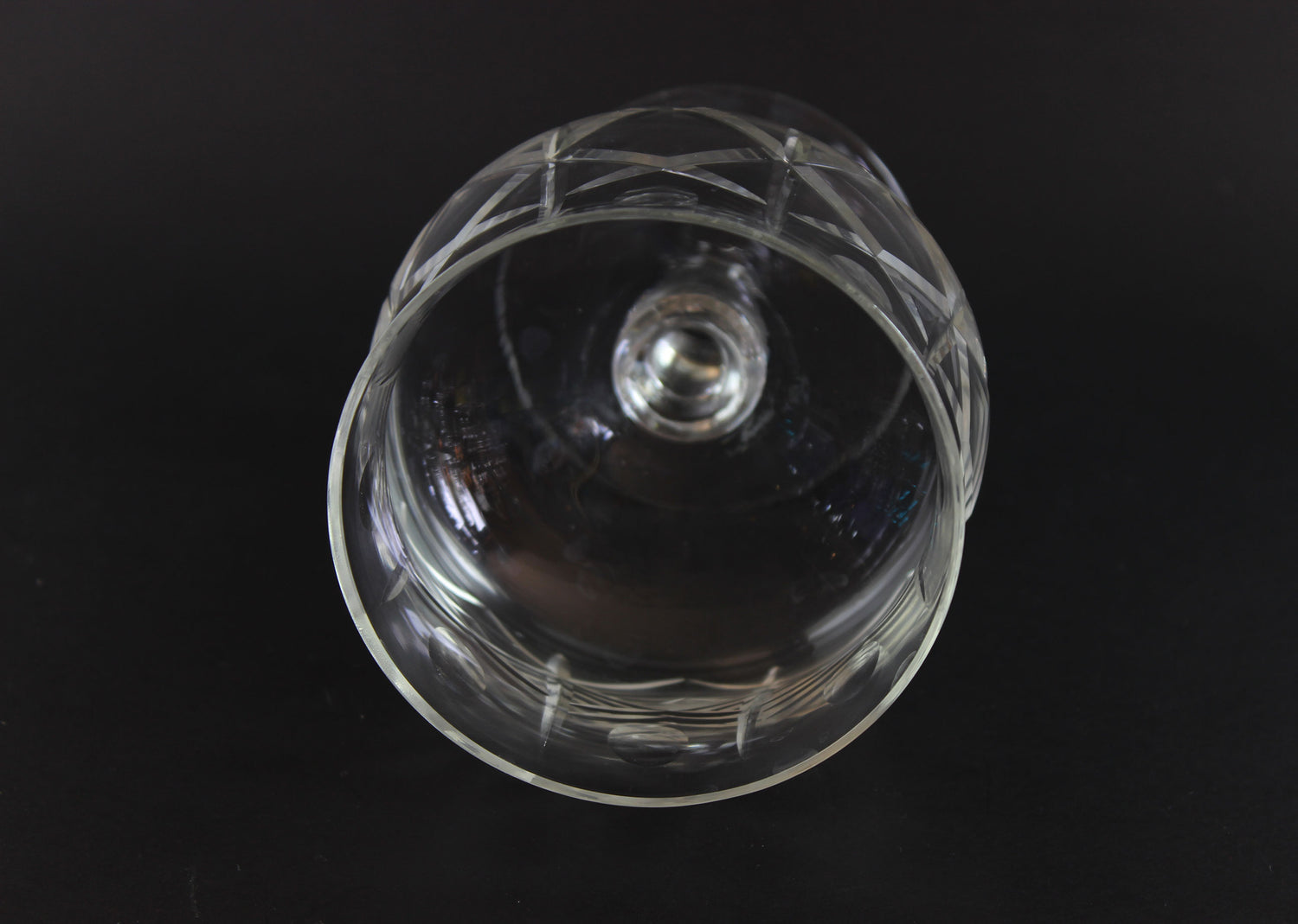 Clear crystal goblet with cross and olive cut pattern on a dark background