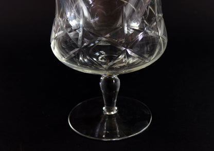 Crystal glass with cut patterns on a black background